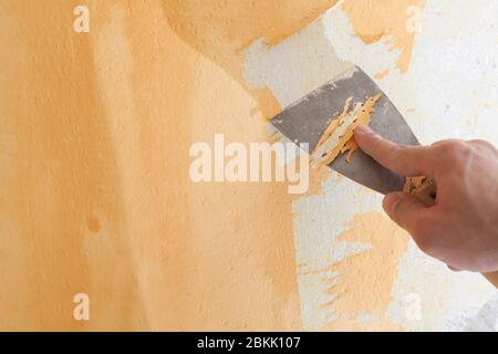 Scraping old plaster and applying new. Reconstruction of a new house. Stock Photo