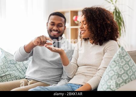 african american couple with smart speaker at home Stock Photo