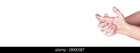 Young man washing hands with soap, wide banner space for text left side, isolated on white. Can be used during coronavirus covid19 outbreak prevention Stock Photo