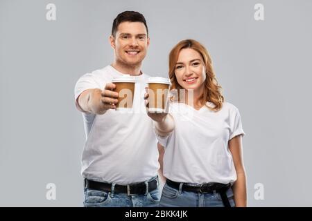 portrait of happy couple with takeaway coffee cups Stock Photo