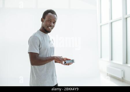 side view. stylish young man using his smartphone. Stock Photo