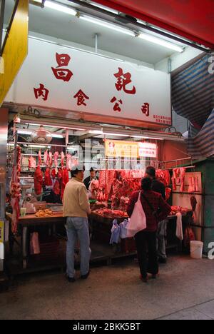 Fresh Red Meat Market Ng Fund Fresh Meat Hanging Meat Display at Night Dark Street Scene in Central Hong Kong Stock Photo