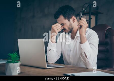 Close-up portrait of his he nice attractive sad unhealthy man sales client manager economist suffering from pain high fever at modern loft industrial Stock Photo