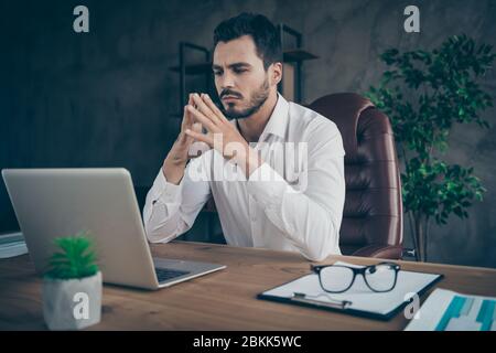 Portrait of his he nice attractive chic classy confident focused man skilled expert economist analyzing data stock exchange at modern loft industrial Stock Photo