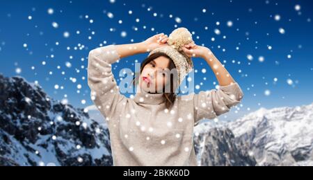 young woman in knitted winter hat and sweater Stock Photo