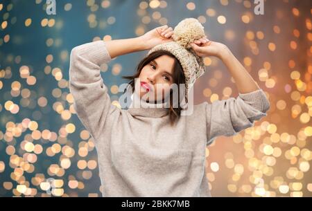 young woman in knitted winter hat and sweater Stock Photo