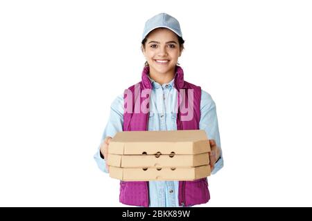 Smiling hispanic woman courier wears uniform hold pizza boxes isolated on white. Stock Photo