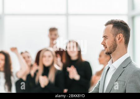 side view. young business man standing in conference room Stock Photo