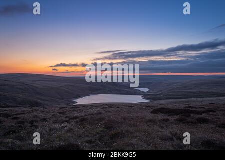 Sunset at Wessenden Head Reservoir with Wessenden Reservoir visible in the distance, south of the town of Marsden, West Yorkshire, UK. Stock Photo