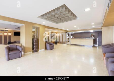 Empty interior of hotel hall with reception desk. Stock Photo