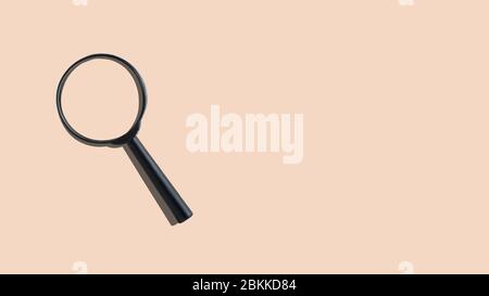 Magnifier on an orange background with copy space. Close up. Stock Photo
