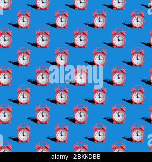 Seamless pattern of analog watches on a blue background. Close up. Stock Photo