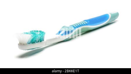 Old dirty used toothbrush isolated on the white background Stock Photo