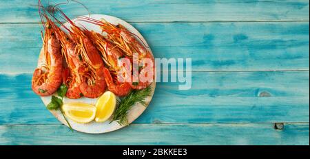 Top view of red big prawns on light blue background Stock Photo
