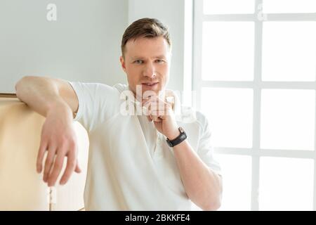 pensive young man standing near cardboard boxes Stock Photo