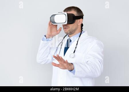 Male Doctor Using Virtual Reality Headset For Medical Purposes Stock Photo