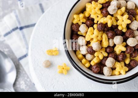 Assorted breakfast cereals: chocolate balls and honey stars Stock Photo