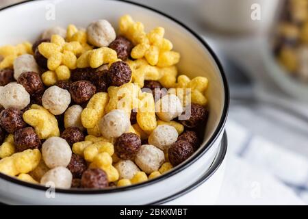 Assorted breakfast cereals: chocolate balls and honey stars Stock Photo