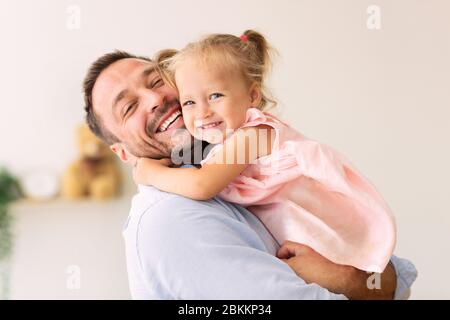 Caucasian father holding his cute loving daughter Stock Photo
