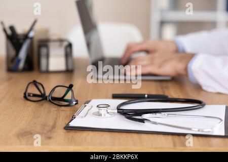 Close up of medical practitioner using laptop, side view Stock Photo