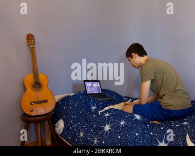 a Caucasian teenager studies in elearing during pandemic Stock Photo