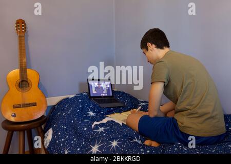 a Caucasian teenager studies in elearing during pandemic Stock Photo