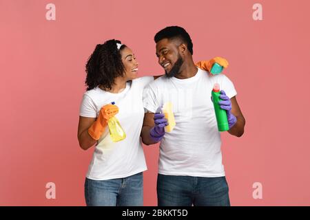 Ready For Cleaning. Happy Black Couple With Household Tools Over Pink Background Stock Photo
