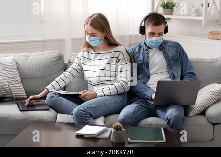 Young man and woman studying and playing at home online Stock Photo