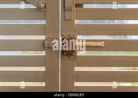 Gray metal driveway entrance gates, closeup view Stock Photo