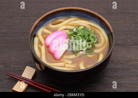 Japanese curry udon noodles in a ceramic bowl on wooden tray Stock Photo