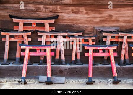 Small wooden orange-red torii gate model with wishes written on them at Shikichi-jinja Shrine (Wara-tenjin). Kyoto. Japan Stock Photo