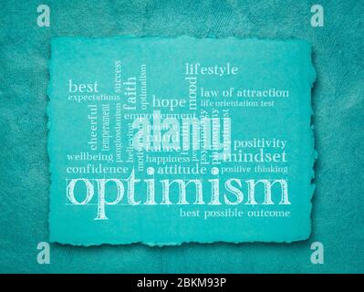 optimism word cloud - handwriting on a blue handmade rag paper, lifestyle, hope and positivity concept Stock Photo