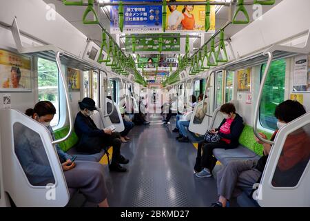 Tokyo, Japan - Golden Week Holiday, May 2, 2020 : Inside JR Yamanote Line people keeping a distance during state of emergency due to Covid-19 Stock Photo