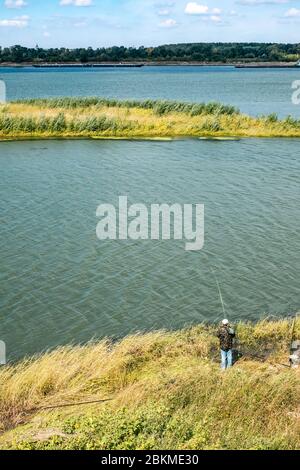 unknown fisherman fished with the rod in the Danube, Ruse city, Bulgaria Stock Photo