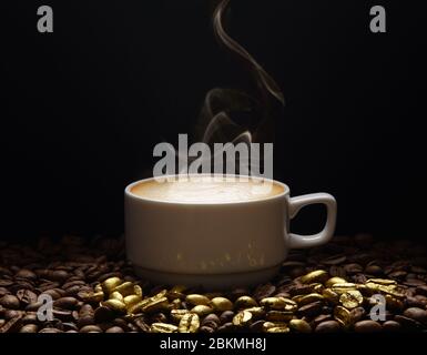 A cup of coffee with smoke on golden coffee beans on a dark background. Space for adding text. Stock Photo
