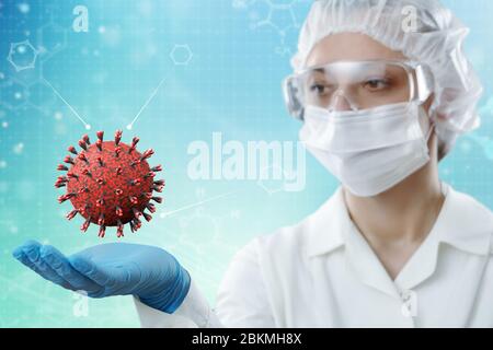 Innovative technologies in science and medicine . Female scientist holding avirus model in the palm of her hand. Medical concept. Stock Photo