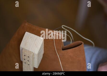 Handmade handicraft leather bag sewing process. Leather workshop, working with leather Stock Photo