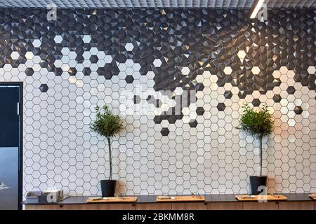 Nicely decorated wall with many small tiles in cafe Stock Photo