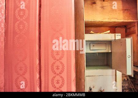 Vintage red wall and open safe in the background Stock Photo