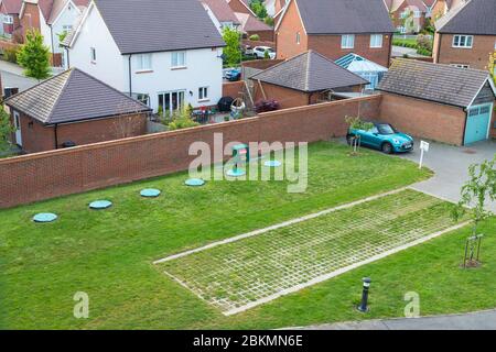 Calor propane gas tanks buried in the ground of a new housing estate with driveway for lorry, kent, uk Stock Photo