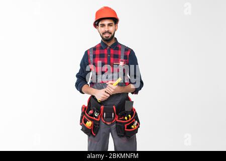 Builder with protective gloves holding hammer and knocking something, isolated on white Stock Photo
