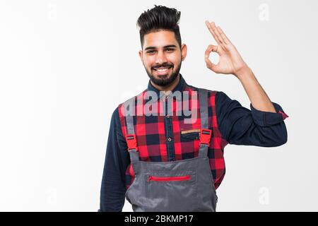 young smiling handyman show positive attitude, isolated on white Stock Photo