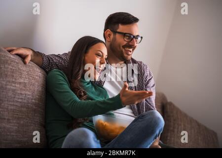 Couple is relaxing at home. They are watching tv. Stock Photo