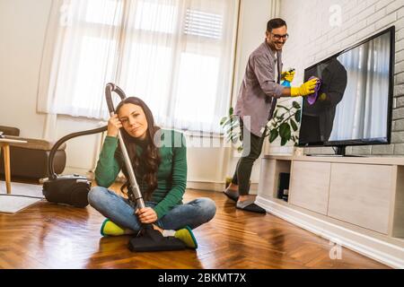 Woman is tired of cleaning the apartment. Stock Photo