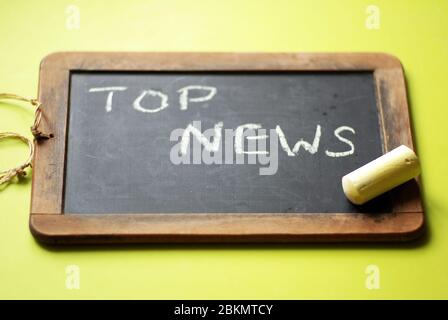 Chalkboard with top news written in chalk Stock Photo