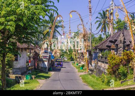 BALI, INDONESIA - 16TH APRIL 2017:  Streets in Bali. Penjor Poles can be seen as part of the annual Galungan Celebration Stock Photo