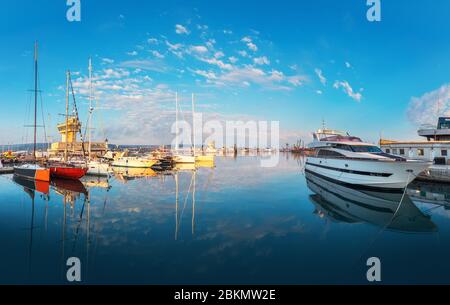 Calm morning at Yacht port Varna, Bulgaria. Sailboat harbor, many beautiful moored sail yachts in the sea. Stock Photo