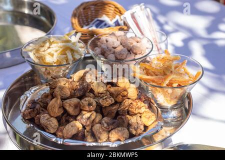 Croatian sweets presented on a plate. Dried fruits like figs, lemons, oranges are sweetened with sugar, and sugared almonds are a typical croatian sna Stock Photo