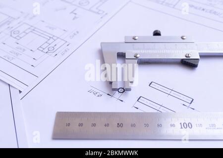 Top view of a caliper measuring tool, ruler and detail drawings.Engineering drawings, metal detail. Stock Photo