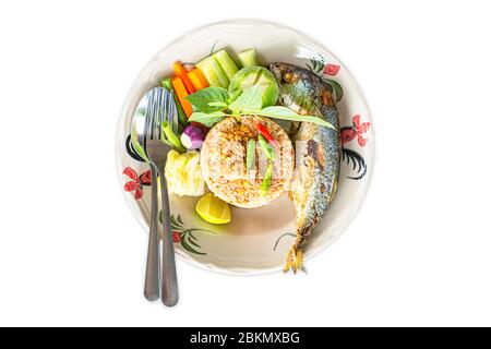 Isolated Fried rice with chili spicy with fish and vegetables in plate on a white background with clipping path. Stock Photo